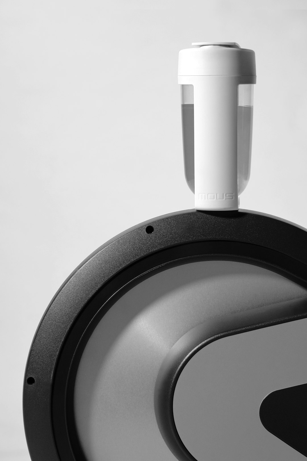 A white water bottle balances elegantly on the flywheel of an Intenza 550 GC3 Group Cycle.